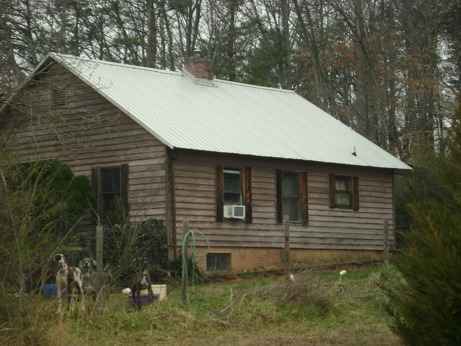 White metal roof on an old wood sided farmhouse, from a Metal Roof Installation job in Mc Leansville